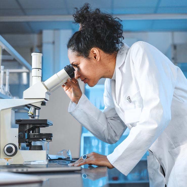 scientist looking at vial